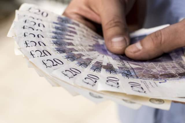A Generic Photo of a man holding a wad of twenty pound notes. See PA Feature FINANCE Lifetime ISA. Picture credit should read: PA Photo/thinkstockphotos. WARNING: This picture must only be used to accompany PA Feature FINANCE Lifetime ISA. FINANCE_Lifetime_ISA_100537.JPG