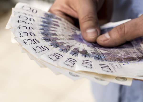A Generic Photo of a man holding a wad of twenty pound notes. See PA Feature FINANCE Lifetime ISA. Picture credit should read: PA Photo/thinkstockphotos. WARNING: This picture must only be used to accompany PA Feature FINANCE Lifetime ISA. FINANCE_Lifetime_ISA_100537.JPG