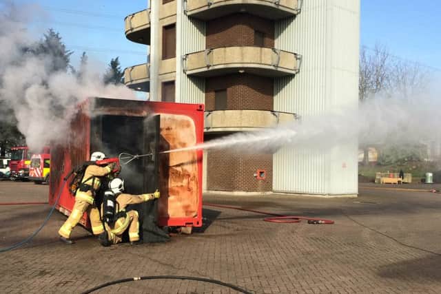 Fire crews demonstrating a high-pressure lance