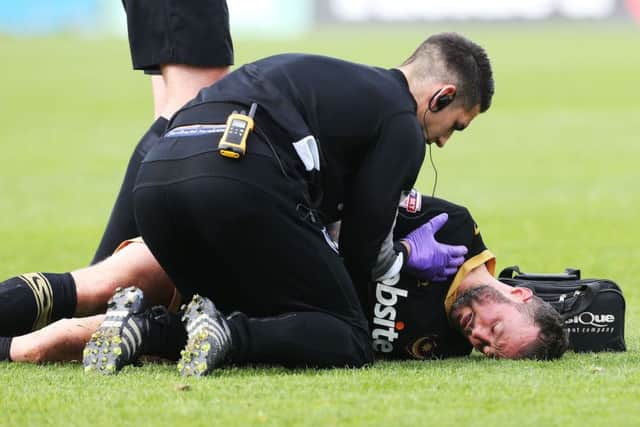 Noel Hunt receives treatment on the pitch Picture: Joe Pepler
