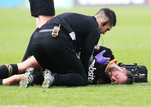 Noel Hunt receives treatment on the pitch Picture: Joe Pepler