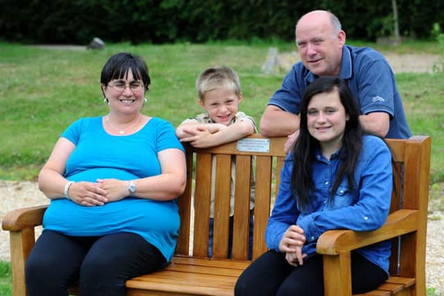 (l-r) Marie Robinson, Liam Robinson, Terry Robinson and Natalie Robinson with the bench in memory of Jack at Denmead cemetery. Picture: Allan Hutchings