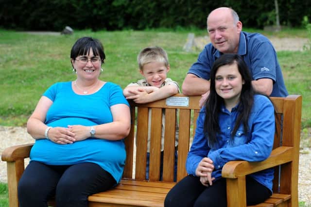 (l-r) Marie Robinson, Liam Robinson, Terry Robinson and Natalie Robinson with the bench in memory of Jack at Denmead cemetery.
 
Picture: Allan Hutchings