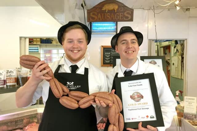 Nathan Jones-Morris holding his award-winning sausages and Tull's owner Ben Sawyers with the certificate