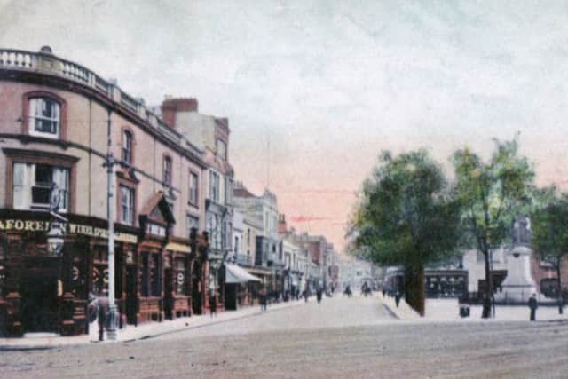 It is 1910 and the leaves are coming out on the trees in the spring scene looking down Russell Street from the Guildhall Square.