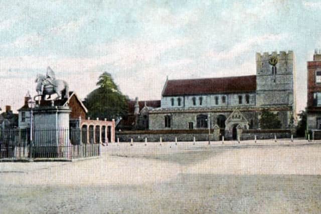 The Norman St Peters Church with the statue of William III on horseback in the square.