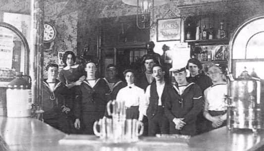 Inside the Jubile Arms in St James' Street, c. 1890. The picture captures the close connection between drinking establishments and sailors in Portsmouth, and the connections sailors had with local residents and female proprietors