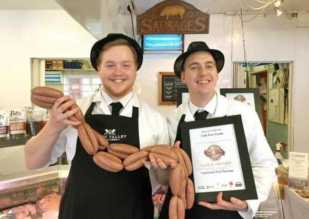 Nathan Jones-Morris holding his award-winning sausages and Tull's owner Ben Sawyers with the certificate