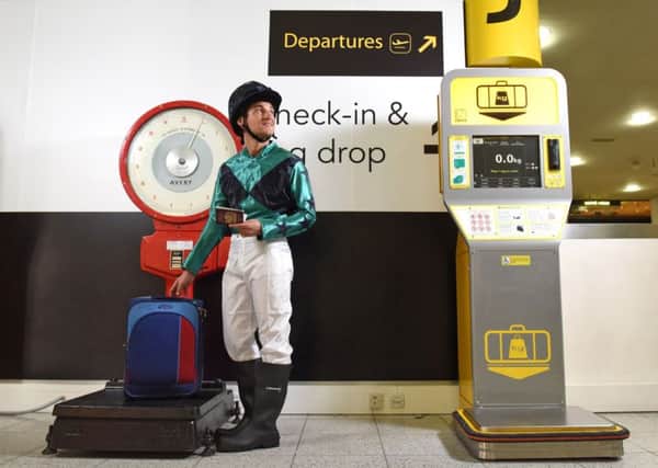 To celebrate 100 years since Gatwick Racecourse hosted the 1917 Grand National, Gatwick Airport has installed authentic jockey scales in the South Terminal. The jockey pictured is wearing traditional silks in Gatwick colours