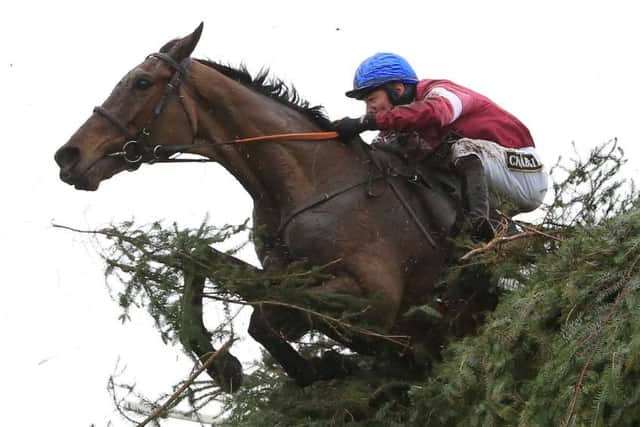 Jockey David Mullins jumps the last fence onboard Rule The World during the Crabbie's Grand National Chase during Grand National Day of the Crabbie's Grand National Festival at Aintree Racecourse, Liverpool.l. PRESS ASSOCIATION Photo. Picture date: Saturday April 9, 2016. See PA story RACING National. Photo credit should read: Mike Egerton/PA Wire EMN-160415-143233002