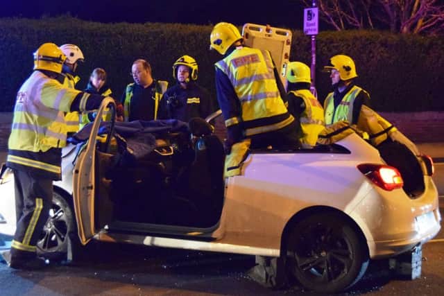 Firefighters from Southsea work to free the injured man from his car after cutting the roof off. Two cars crashed in Eastern Road on April 6 at 8pm
