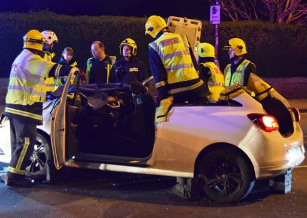 Firefighters from Southsea work to free the injured man from his car after cutting the roof off. Two cars crashed in Eastern Road on April 6 at 8pm