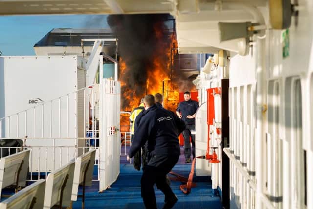 Crew of the Wightlink ferry, St Faith, extinguish a fire in January. The company has now banned smoking on its vessels 
Picture: Christopher Ison