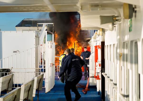 Crew of the Wightlink ferry, St Faith, extinguish a fire in January. The company has now banned smoking on its vessels 
Picture: Christopher Ison
