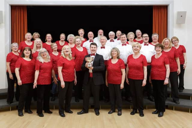 Folks in Harmony pose with the Choir of the Day cup