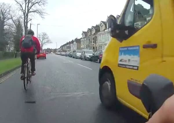 A Colas truck overtaking two cyclists, including the undercover police cyclist