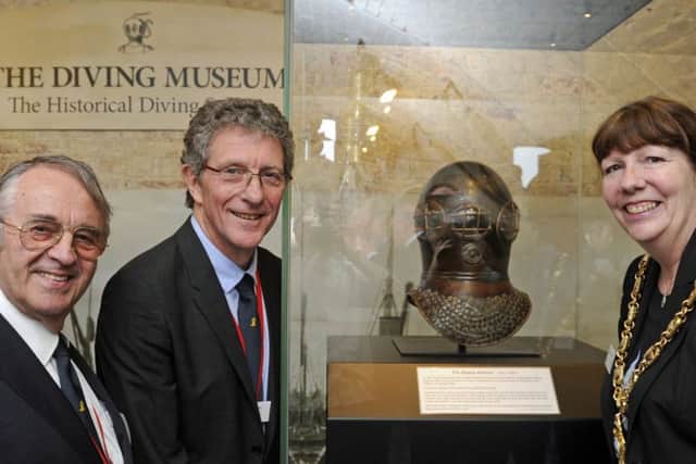 From left, chairman John Bevan, Kevin Casey, and The Mayor of Gosport Councillor, Lynn Hook at the Diving Museum with a new arrival, the world's oldest diving helmet Picture: Ian Hargreaves (170347-2)