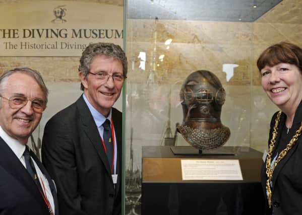 From left, chairman John Bevan, Kevin Casey, and The Mayor of Gosport Councillor, Lynn Hook at the Diving Museum with a new arrival, the world's oldest diving helmet 
Picture: Ian Hargreaves (170347-2)