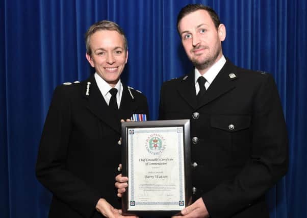 PC Barry Watson receiving the commendation from chief constable OIivia Pinkney