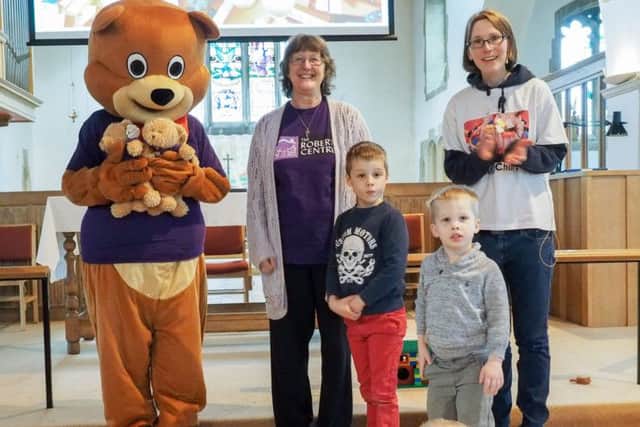 Kathryn Brewer from The Roberts Centre, Jack and Toby Stoneman and Julie Minter, Student Minister at Farlington Parish, with the Robert bears they bought for children supported by the charity
