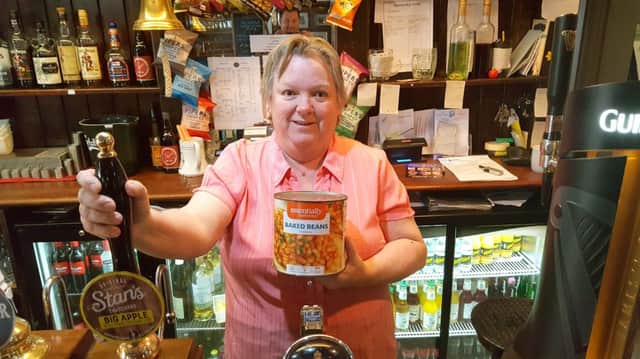 Landlady Marilyn Forster is preparing to wallow in a bath of baked beans for charity