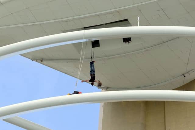 Dan hanging from the Spinnaker Tower after successfully escaping the straitjacket