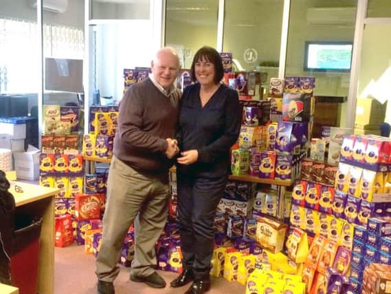 Dave Baker, chairman of CJS Portsmouth with Terri Gray and hundreds of Easter eggs