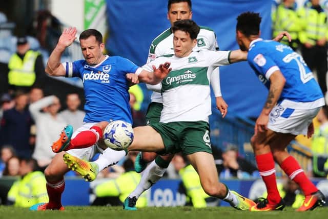 Michael Doyle challenges Connor Smith for the ball during today's game at Fratton Park Picture: Joe Pepler