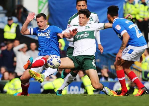 Michael Doyle challenges Connor Smith for the ball during today's game at Fratton Park Picture: Joe Pepler