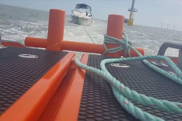 The motor boat being towed to safety. Picture: GAFIRS