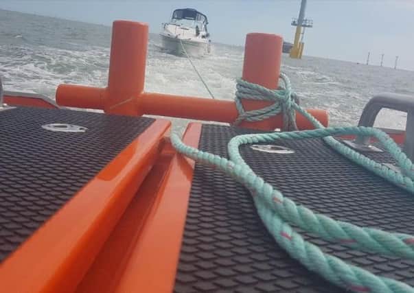 The motor boat being towed to safety. Picture: GAFIRS