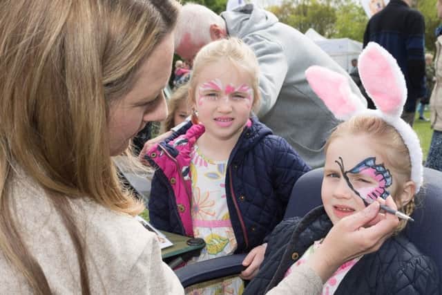 Nicole Carty paints four-year-old Millie Clark's face whilst her sister Beatrix looks on Picture: Keith Woodland (170440-017)