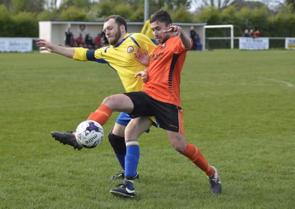 Alex Baldacchino battles for AFC Portchester against Lymington. Picture: Neil Marshall