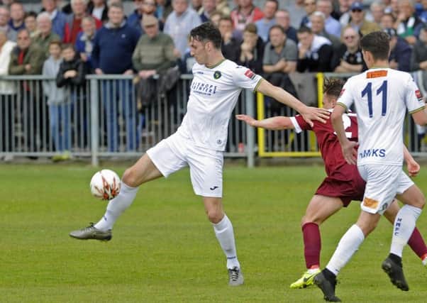 Jason Prior holds off Rocks player Calvin Davies. Picture: Ian Hargreaves