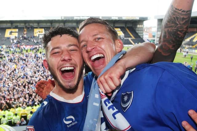 Conor Chaplin celebrates promotion with team-mate Carl Baker, right. Picture: Joe Pepler