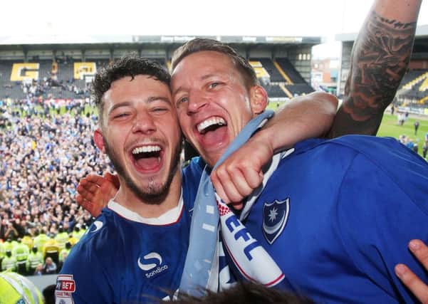 Conor Chaplin celebrates promotion with team-mate Carl Baker, right. Picture: Joe Pepler