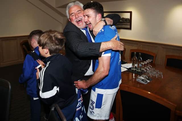 Iain McInnes hugs Enda Stevens after Pompey sealed promotion. Picture: Joe Pepler