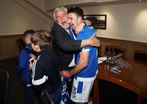 Iain McInnes hugs Enda Stevens after Pompey sealed promotion. Picture: Joe Pepler