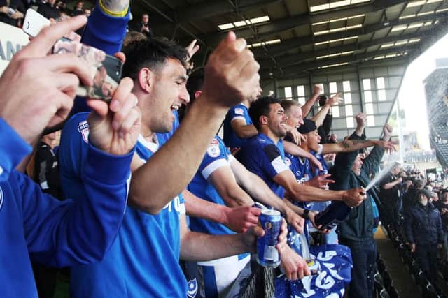 The Pompey players celebrate promotion from the boardroom balcony at Meadow Lane following Mondays 3-1 win against Notts County Picture: Joe Pepler