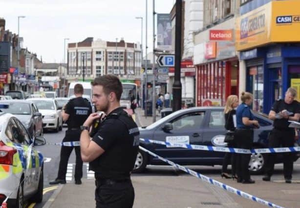 Police outside Barclays Bank in London Road, North End, on July 9, 2016, after a woman was stabbed Picture: Loughlan Campbell