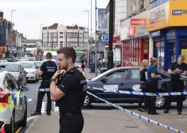 Police outside Barclays Bank in London Road, North End, on July 9, 2016, after a woman was stabbed Picture: Loughlan Campbell