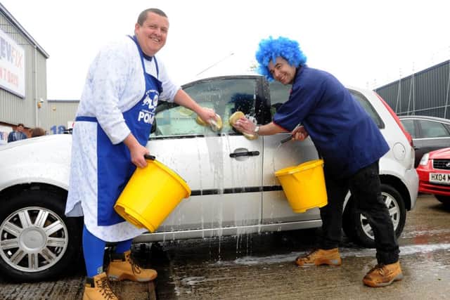 Screwfix manager Steve Whiteaway (left) with Paul Bekker during a charity car wash for Blue Day in 2015