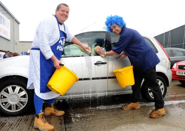 Screwfix manager Steve Whiteaway (left) with  Paul Bekker during a charity car wash for Blue Day in 2015