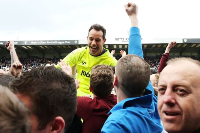 Pompey keeper David Forde is held aloft by Pompey fans on the pitch at Meadow Lane