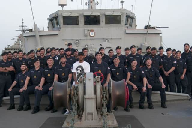 Members of the ship's company of HMS Middleton welcomed Formula One star Lewis Hamilton on board