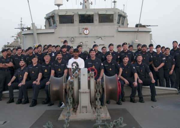 Members of the ship's company of HMS Middleton welcomed Formula One star Lewis Hamilton on board