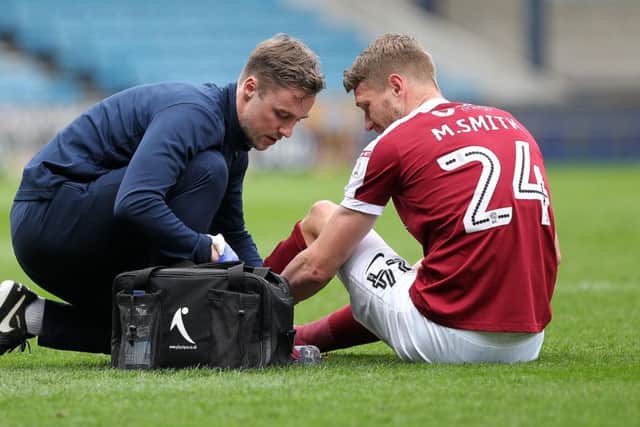 Michael Smith after being injured for Northampton against Millwall Picture: Sharon Lucey