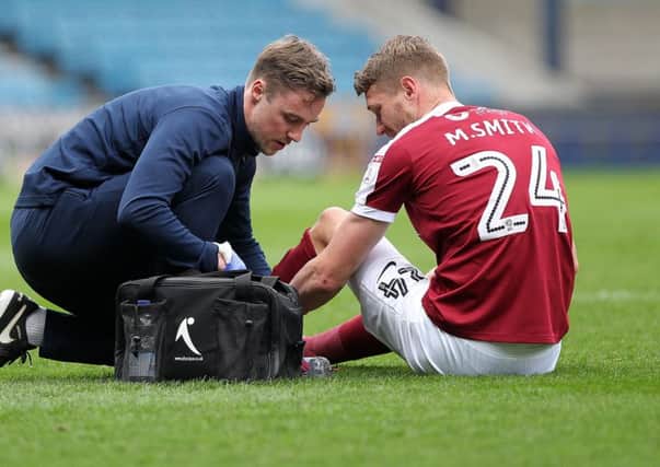 Michael Smith after being injured for Northampton against Millwall Picture: Sharon Lucey