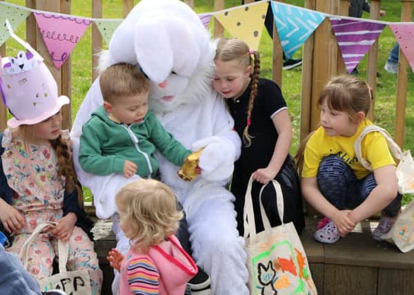 Children meet the Easter bunny that arrived by helicopter