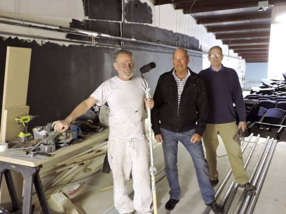 Andrew Bumphrey, Alan James, and Robert 
Mcfarland hard at work refurbishing the new studio theatre